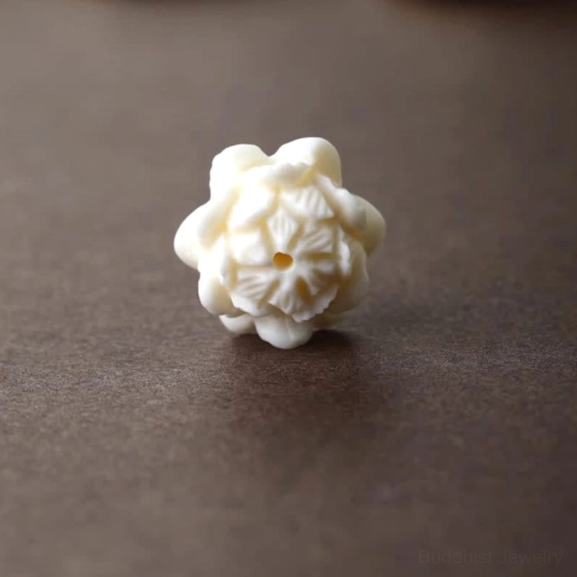 Intricately carved ivory white resin lotus petal detail - top down view