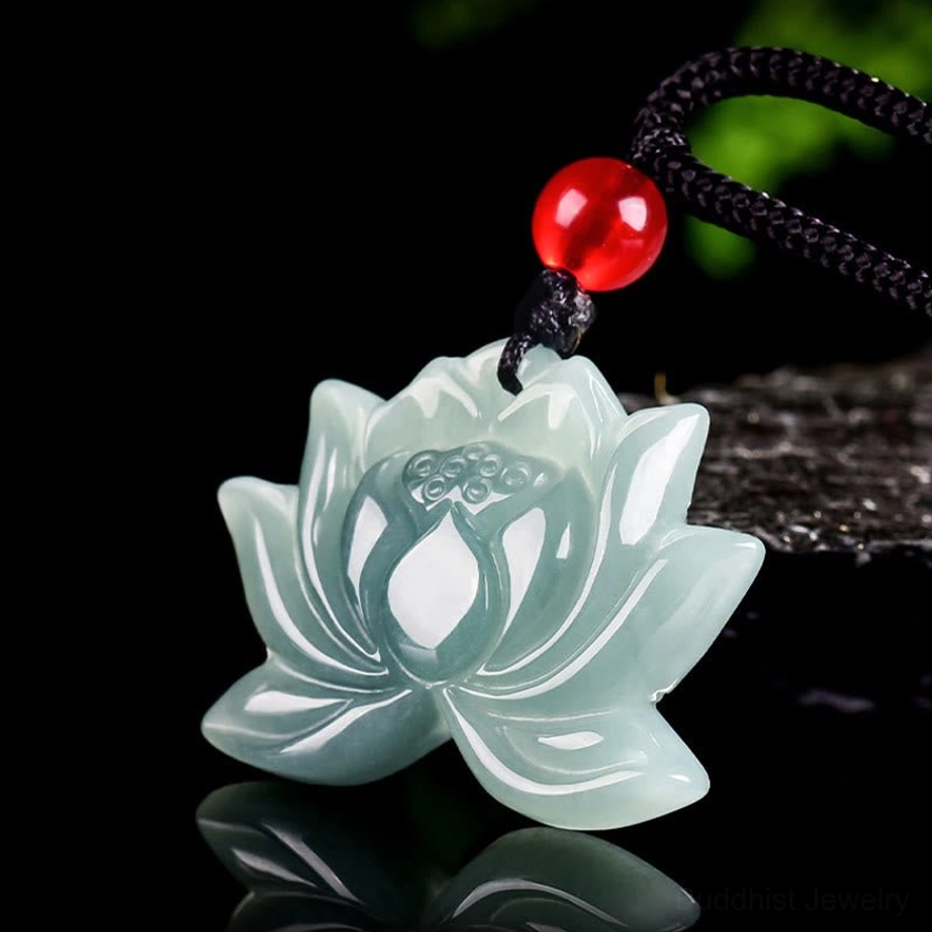 Hand-carved Buddhist lotus jade pendant showing detailed petals and polished finish, three-quarter angle studio shot