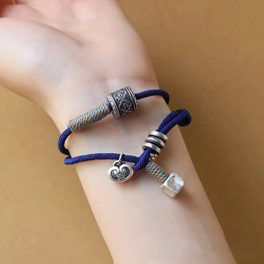Spiritual mantra bracelet close-up on wrist showing carved bead and woven accent details