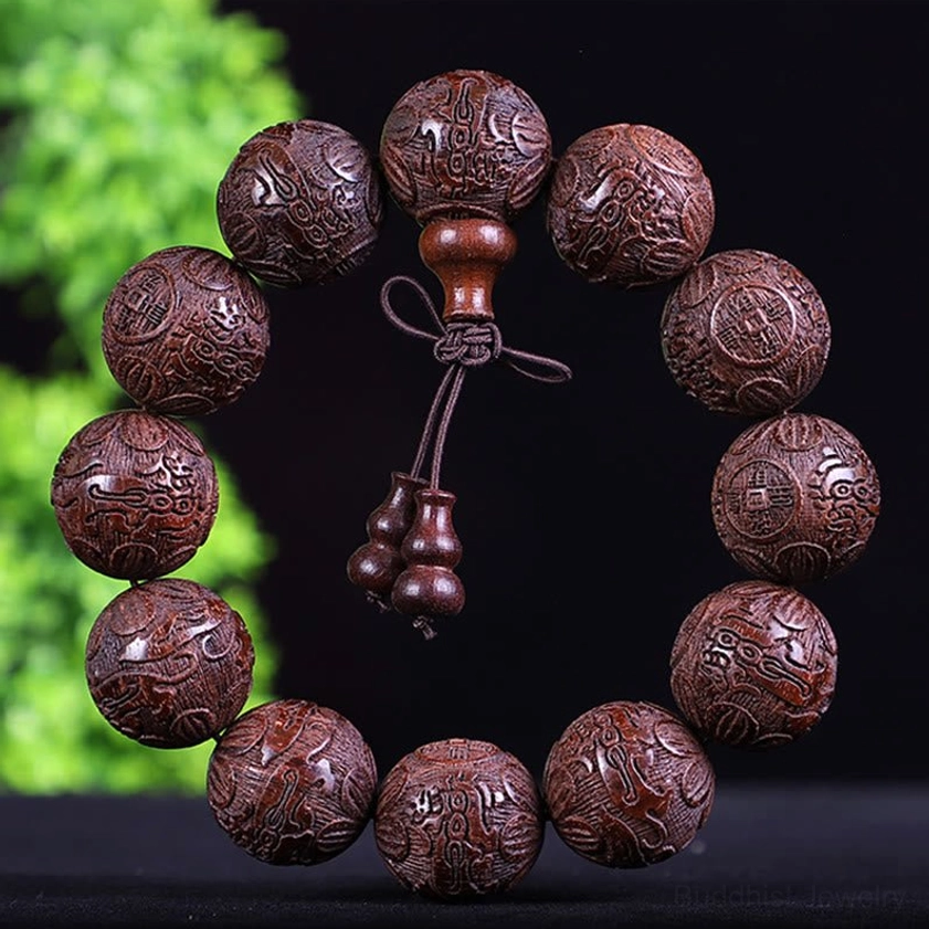 Dark reddish wooden beaded bracelet with carved text beads and traditional gourd pendant, handmade detail