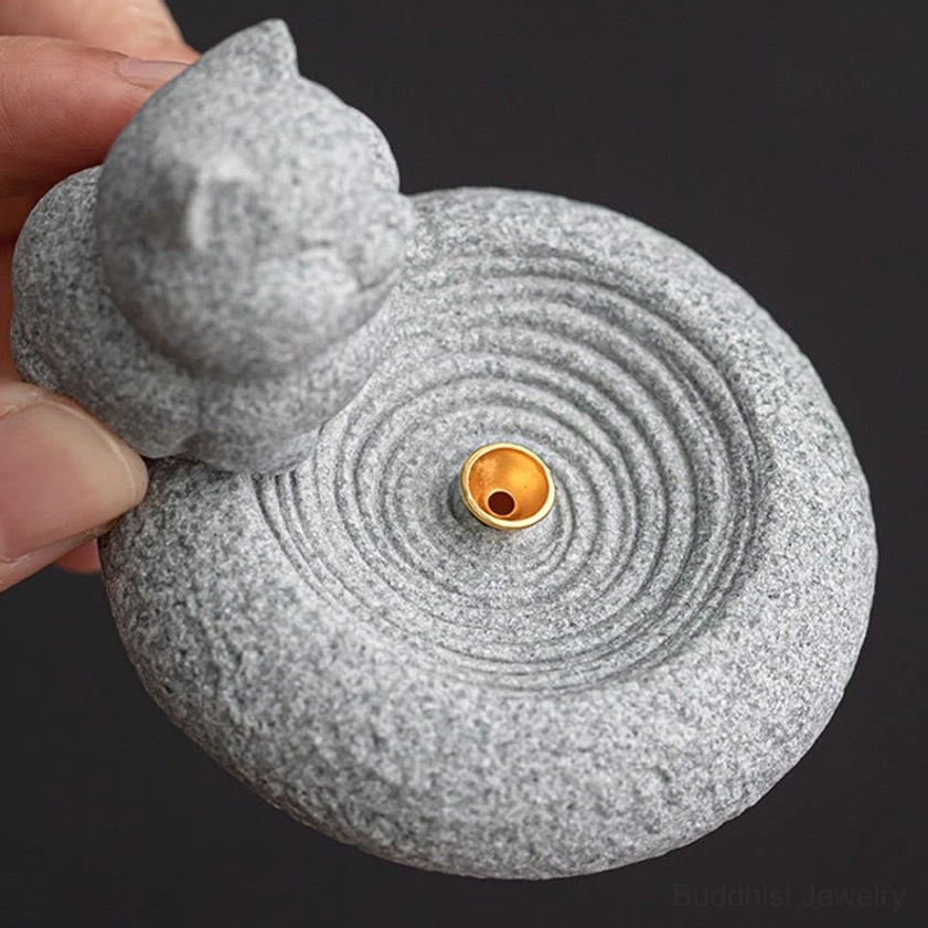 Close-up of cat incense burner ridged base and golden socket detailed texture view