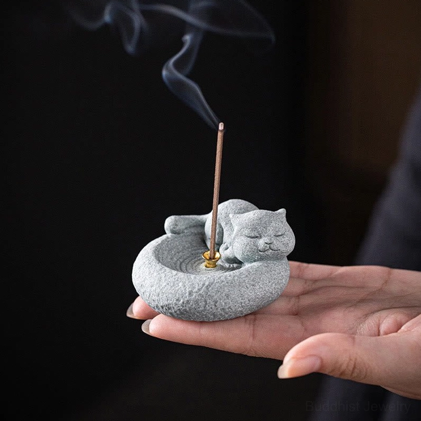 Cat incense burner with incense stick and fragrant smoke rising
