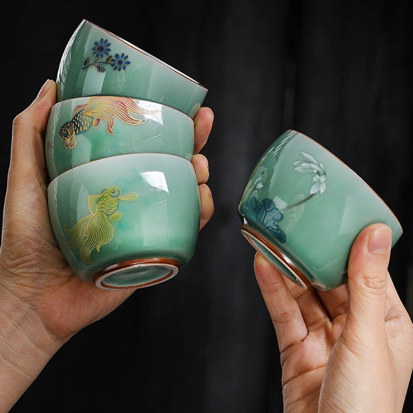 Close-up detail of celadon tea cup silver interior lining showing lustrous protective and decorative gilding finish
