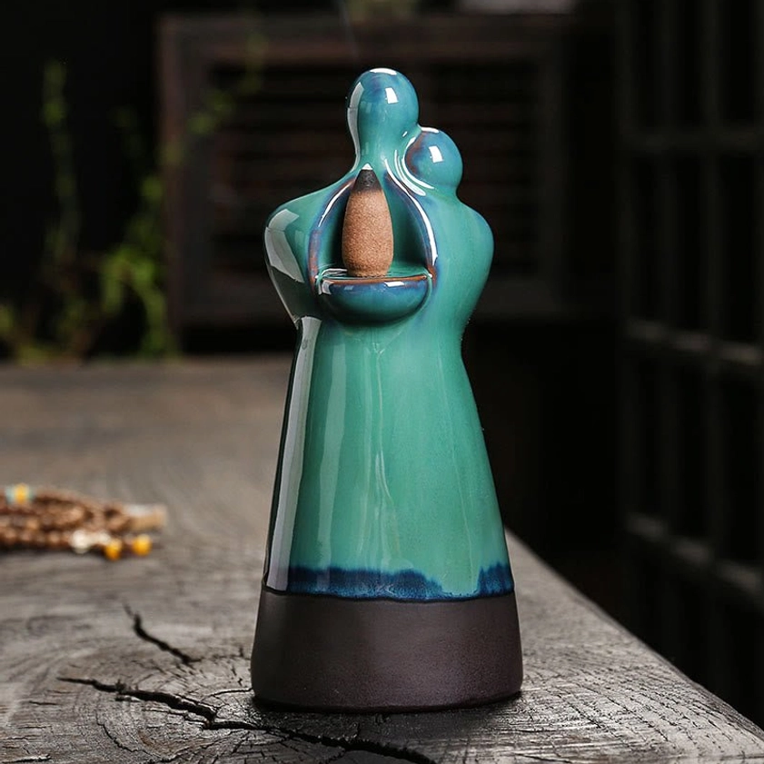 Turquoise ceramic backflow incense burner front view with incense cone placement
