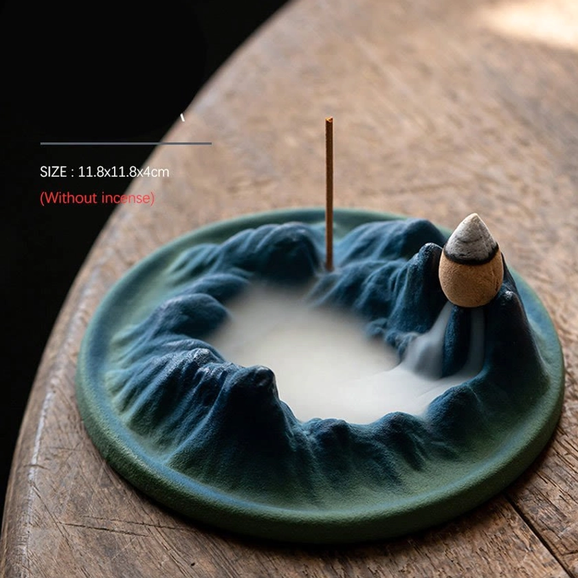 Ceramic Buddhist incense holder in neutral indoor setting, showcasing matte finish and elegant mountain-themed sculptural design