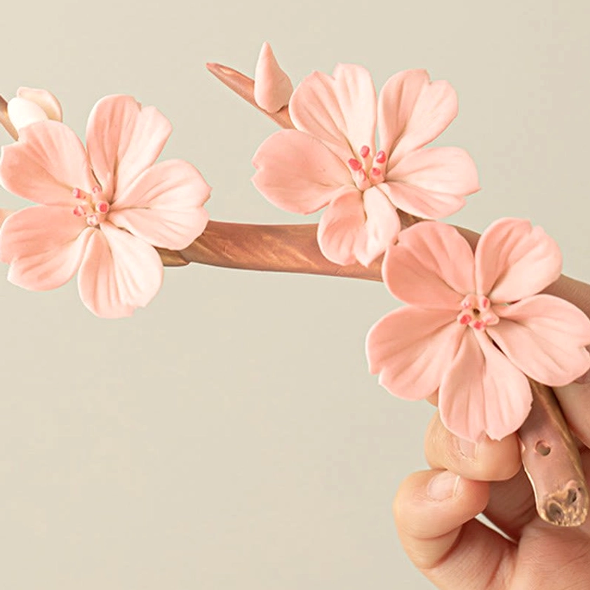 Ceramic plum blossom incense burner showing natural branch design with pink flowers, tabletop mindfulness decoration