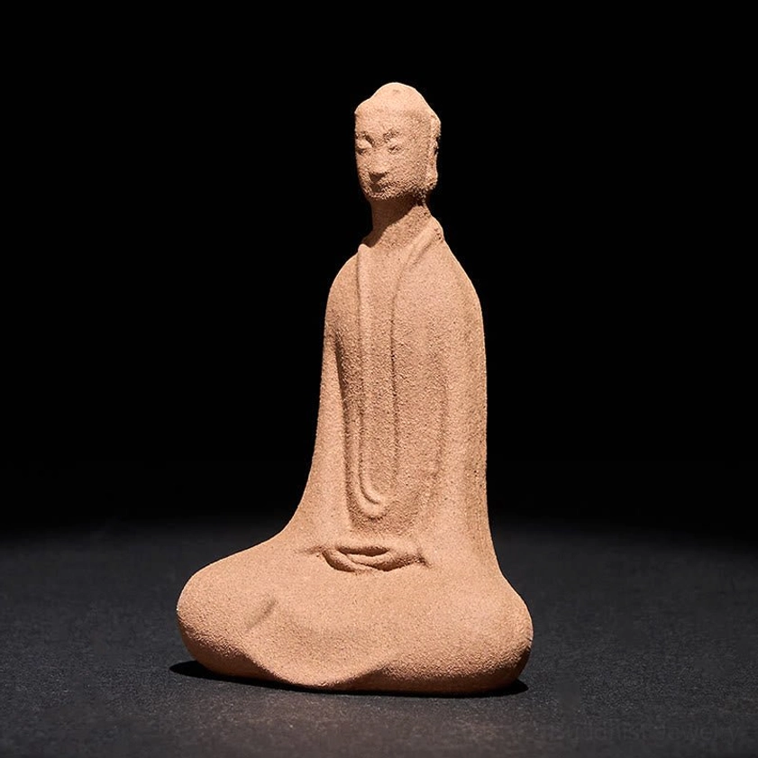 Handcrafted ceramic meditating Buddha statue with matte earthy brown finish, front view showing meditative pose on dark tabletop