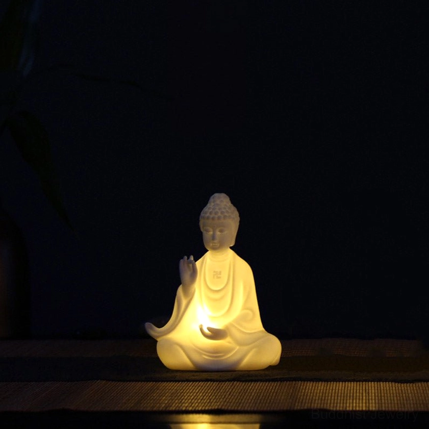 Single handcrafted ceramic Buddha statue with meditation mudra and warm chest-mounted LED light creating peaceful ambiance