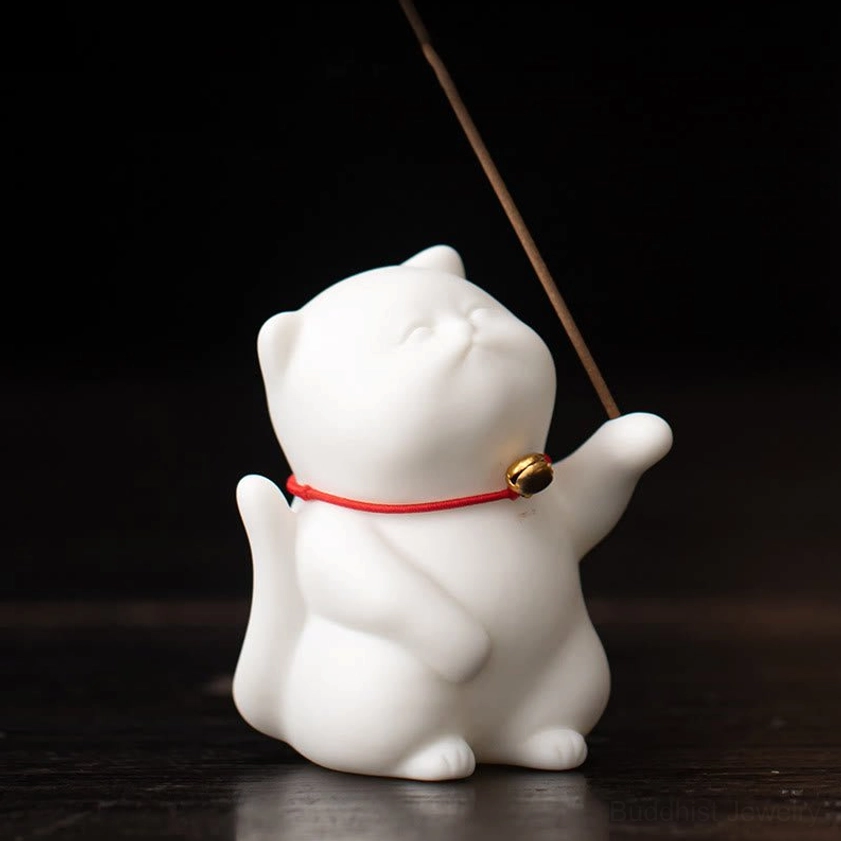 Matte white porcelain cat incense holder close-up side view showing detailed chubby cat shape and rising smoke