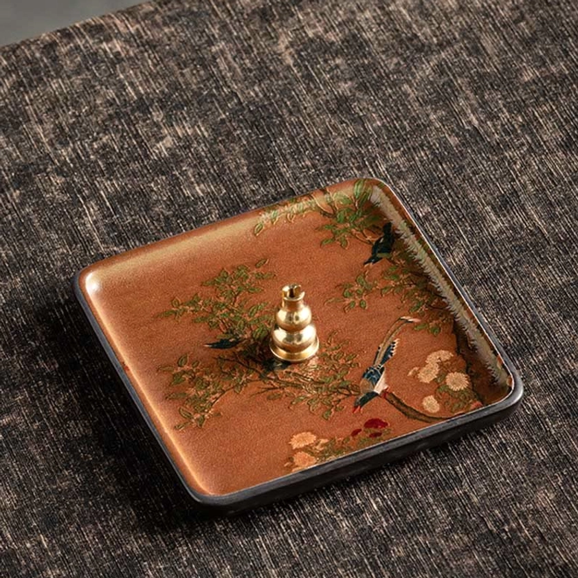 Handcrafted ceramic burner with branch and bird design representing natural harmony and spiritual peace