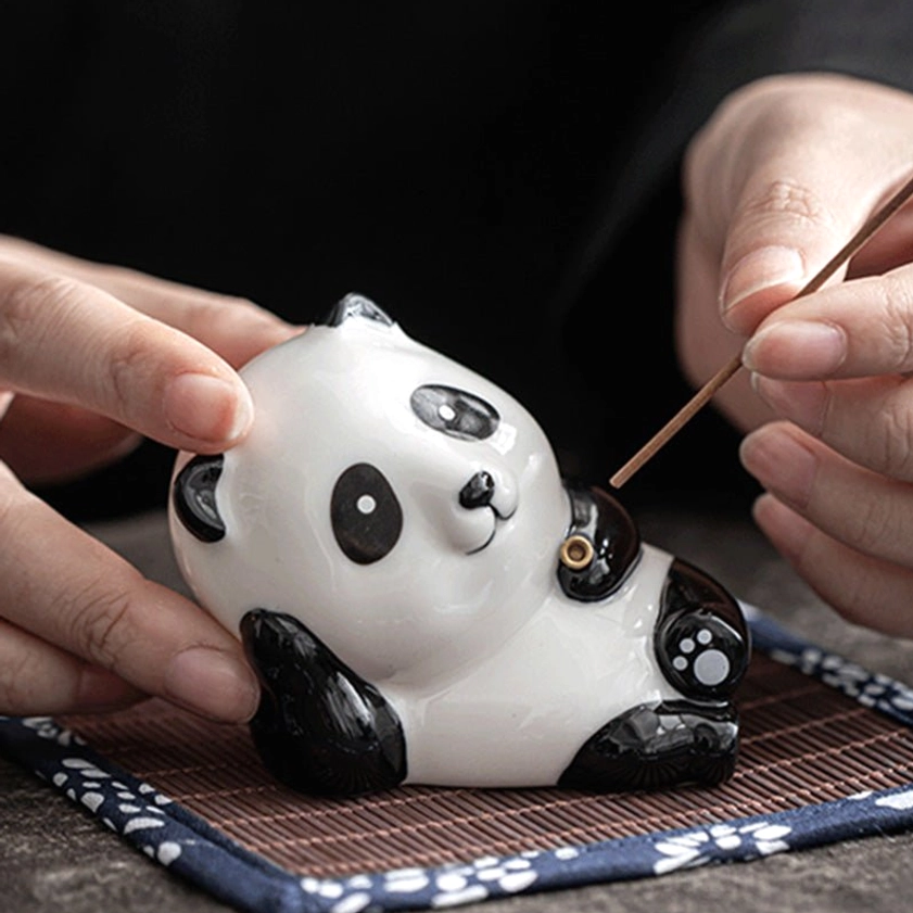 Ceramic incense burner collection featuring cat and panda designs in different colors, showing variety of handcrafted Buddhist spiritual tools