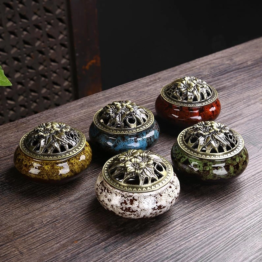 Five color variants of handcrafted ceramic incense burners displayed overhead - red blue green white yellow with bronze lids