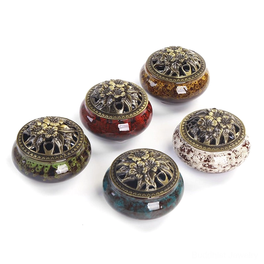 Six color options of handcrafted ceramic Buddhist incense burners with bronze carved ventilated lids flat lay