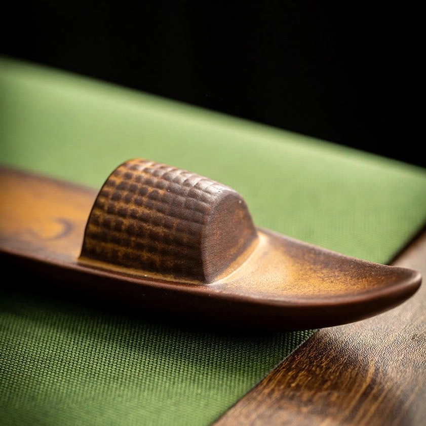 Top-down view of ceramic boat incense burner showing woven textured cabin and gradient brown finish