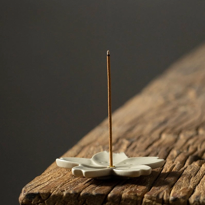 Ceramic flower incense holder low angle side view showing petal structure and metal incense pin