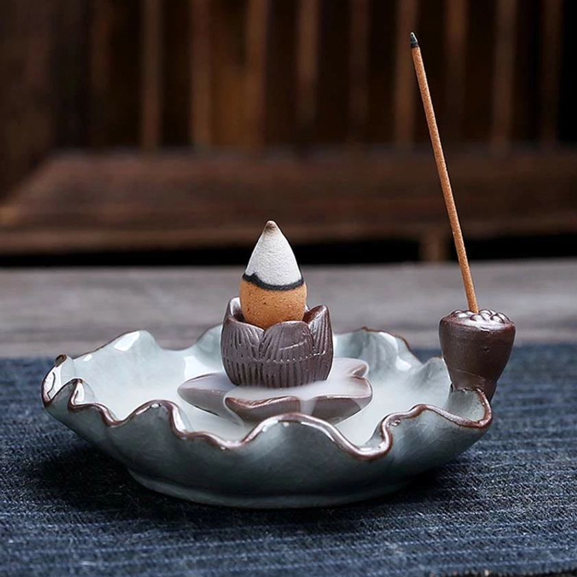 Three-quarter side view of lotus ceramic incense burner with pale celadon crackle glaze and ruffled lotus tray