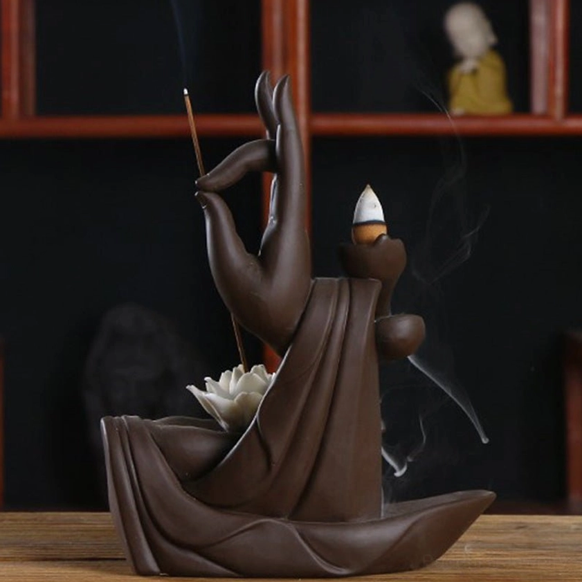 Rear three-quarter view of handmade ceramic lotus incense burner with cone incense and delicate wispy smoke effect