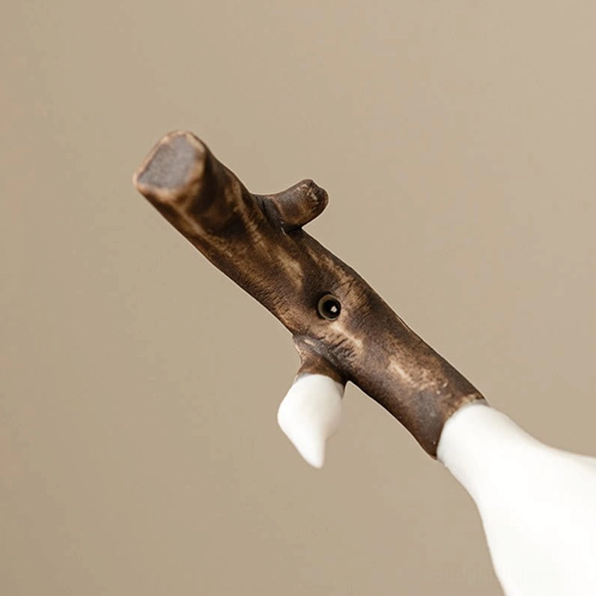 Ceramic magnolia incense holder branch accessory with simulated wood grain, small white ceramic bud, and incense stick hole on beige background