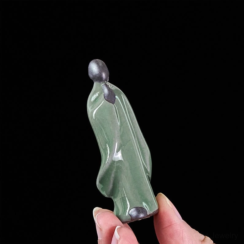 Ceramic meditation monk statue showing glazed ceramic texture artistic detail