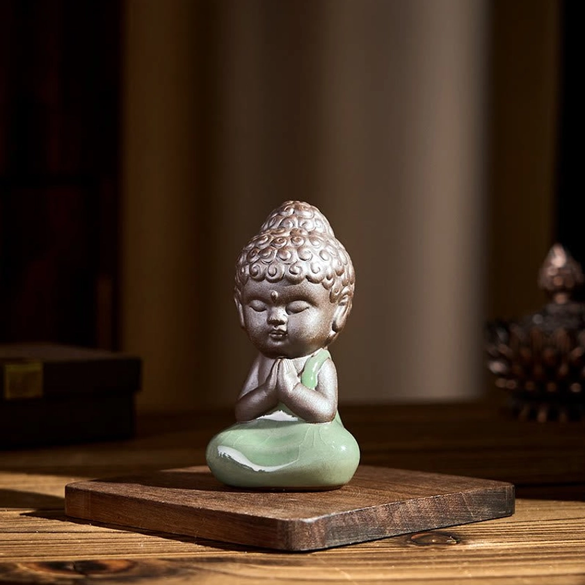 Spiritual ceramic monk statue with incense burner in warm wooden interior setting