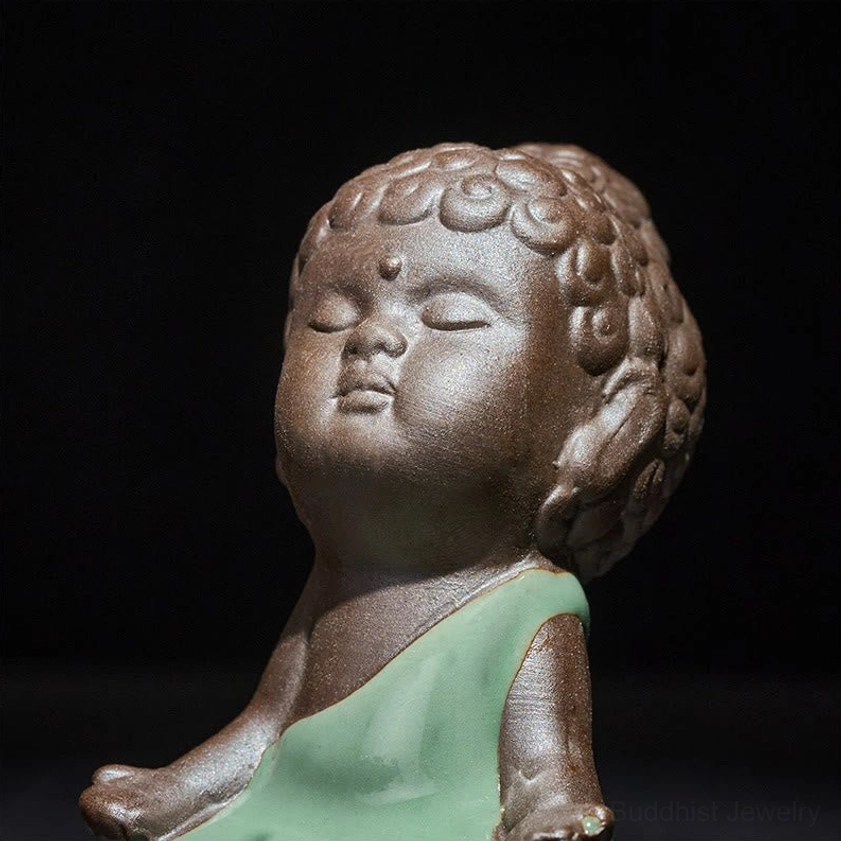 Ceramic meditation monk statue detail showing glazed and matte ceramic surfaces
