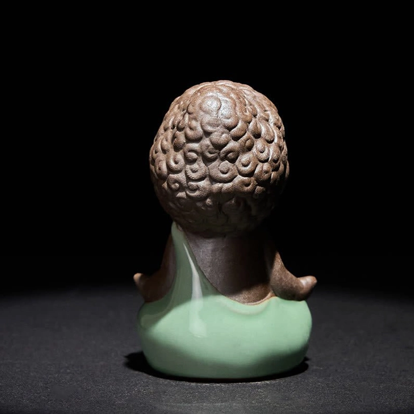 Ceramic Buddhist monk statue with matte finish in meditation seated position