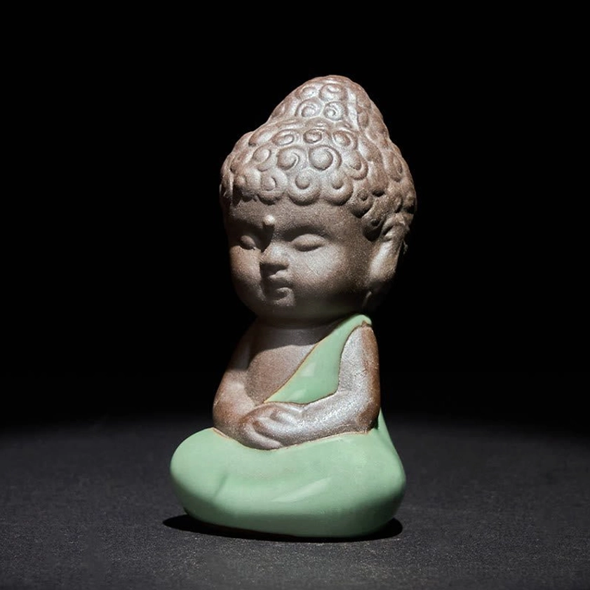 Ceramic meditation monk statue with peaceful serene expression closed eyes