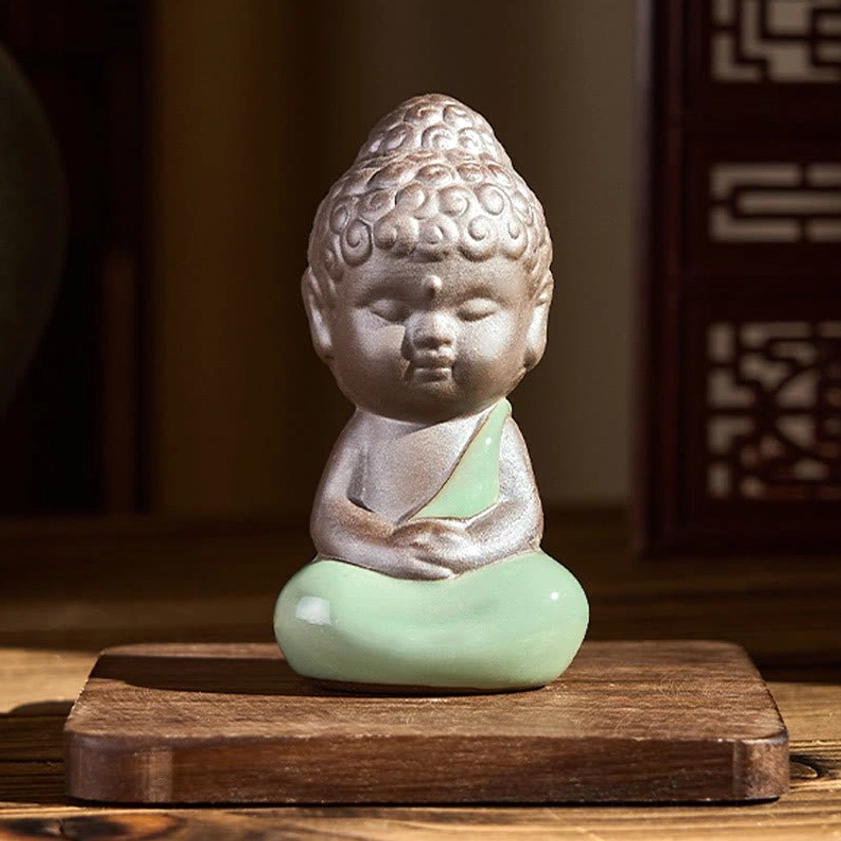 Ceramic meditation monk statue in prayer hands devotion spiritual symbolism