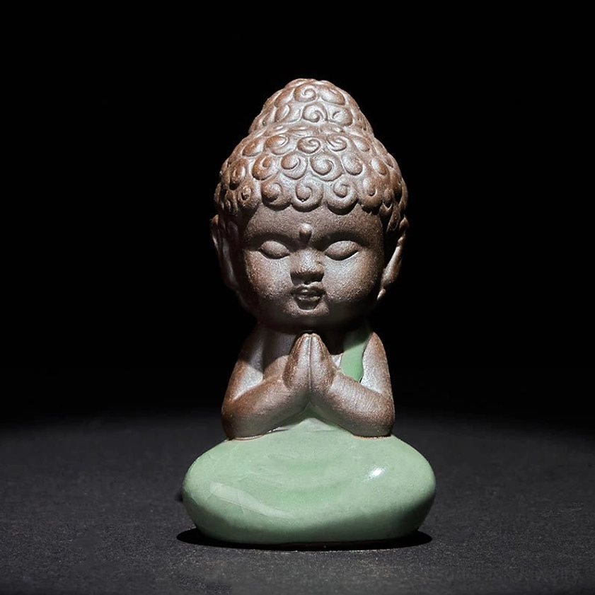 Handcrafted ceramic meditation monk statue in prayer pose with curly Buddha hair and folded hands