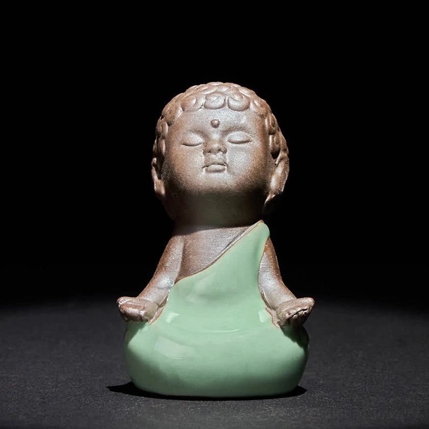 Ceramic meditation monk statue in reflection contemplative pose for introspection
