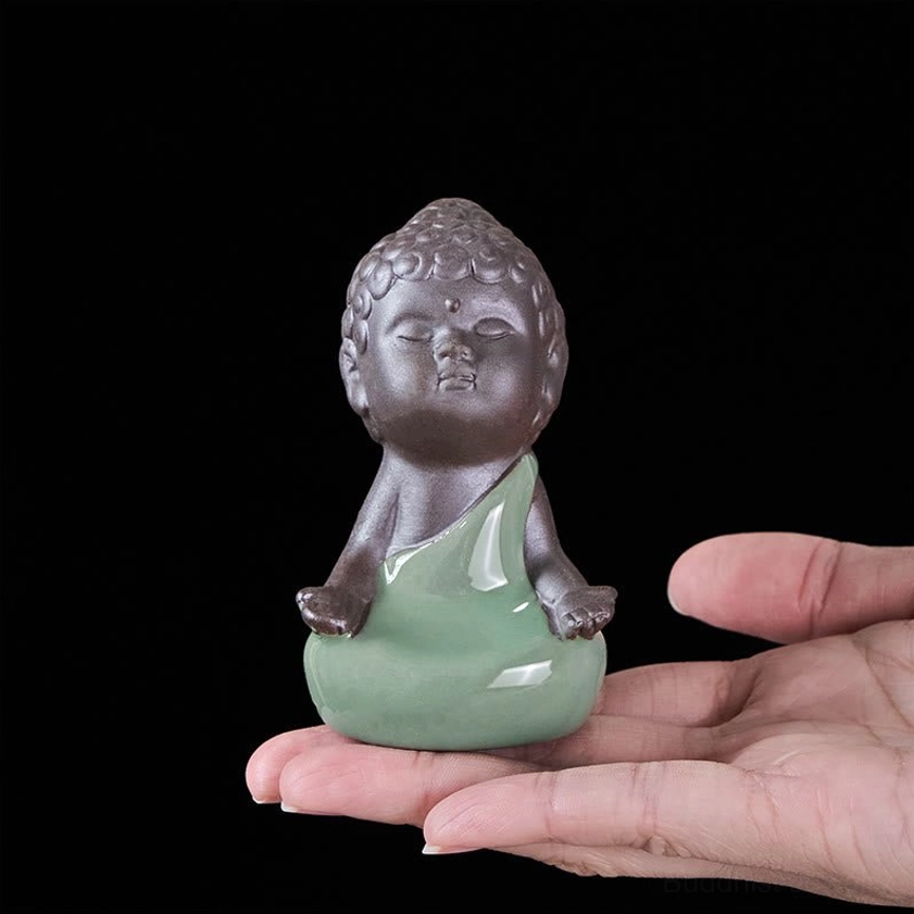 Ceramic meditation monk statue side view showing profile and posture detail
