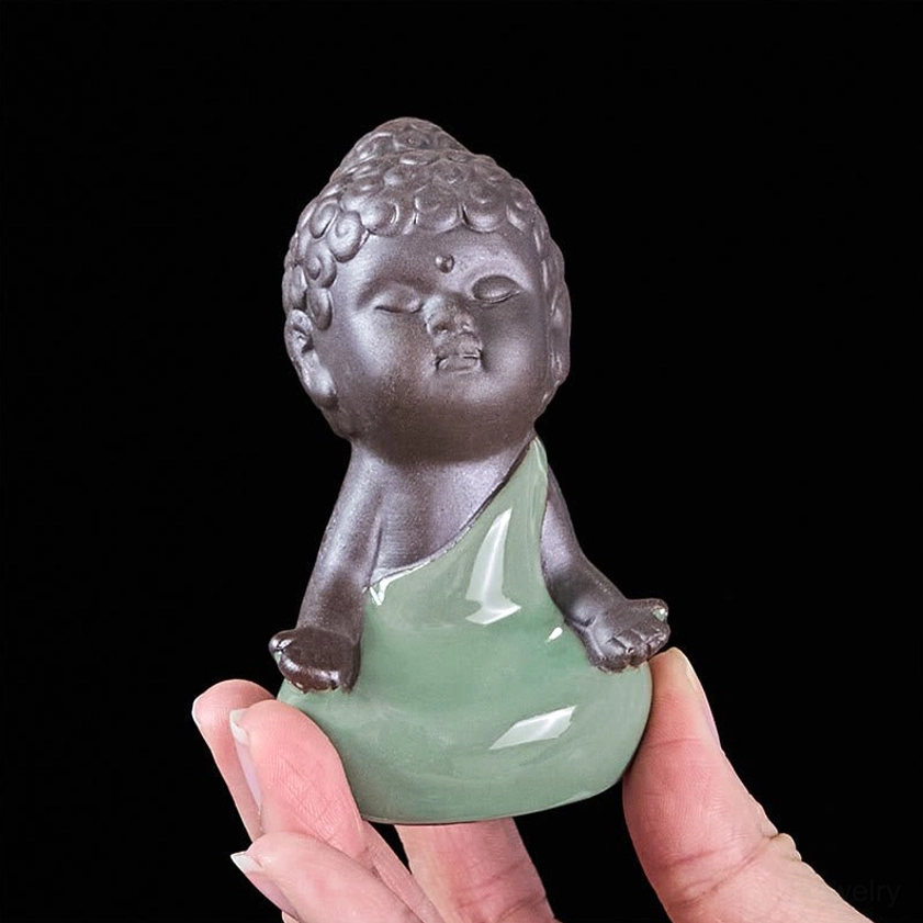 Handcrafted ceramic monk statue in traditional Buddhist meditation posture