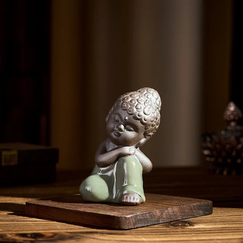 Ceramic meditation monk statue representing wisdom compassion inner peace
