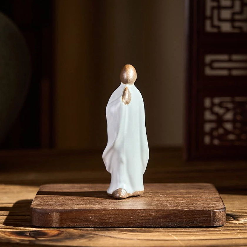 Handcrafted ceramic monk statue detail showing peaceful facial expression and posture