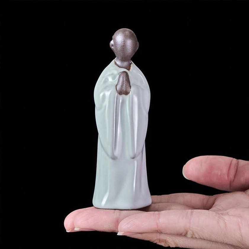 Front view ceramic meditation monk statue with brown head detail and prayer ornament