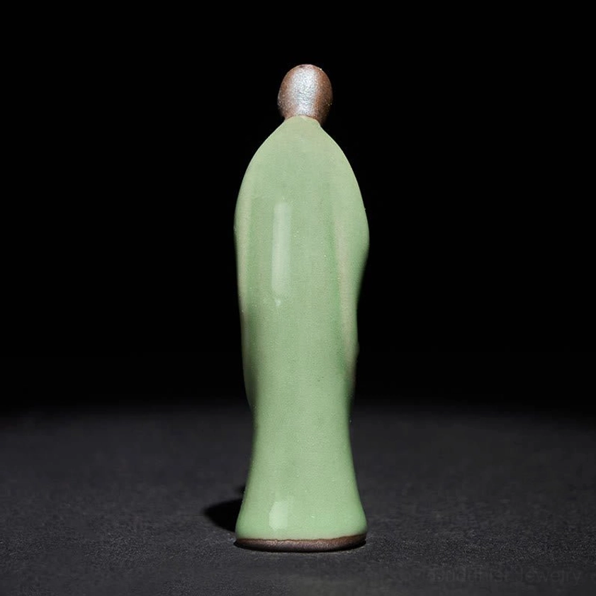 Ceramic monk statue front view serene meditation pose clay figurine