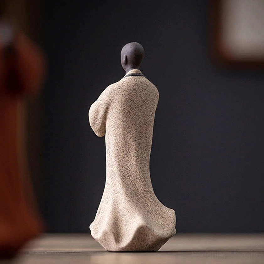 Handcrafted ceramic meditation monk statue with serene expression and peaceful posture for yoga studio decor