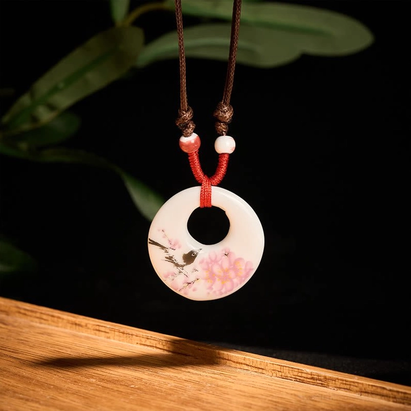 Buddhist ceramic pendant necklace showing authentic hand-painted artisan craftsmanship on pendant surface