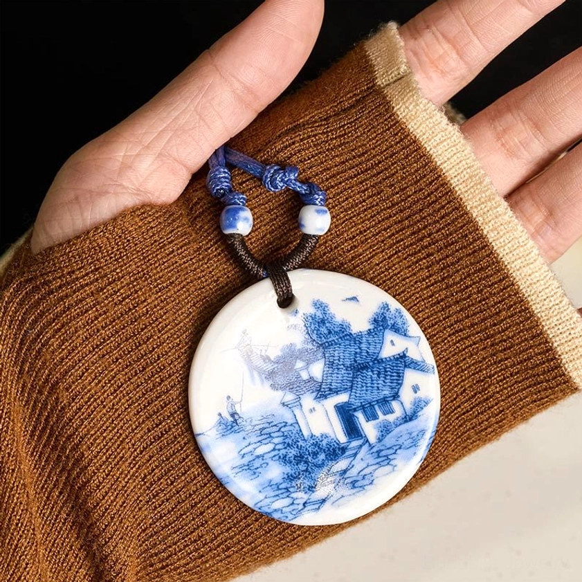 Buddhist ceramic pendant necklace close-up detail of hand-crafted rope attachment and ceramic pendant