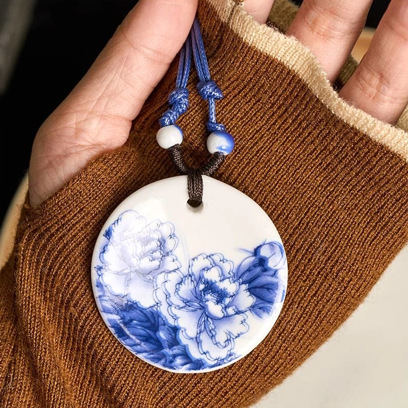 Ceramic pendant necklace detail view showing natural rope construction with ceramic beads