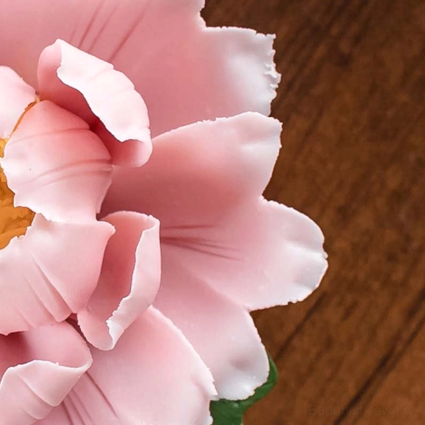 Side view of pink peony incense burner showing curved petals and green leaf base