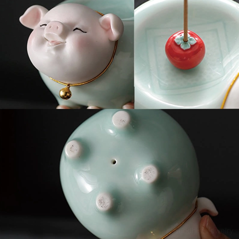 Bottom base view of ceramic pig incense burner showing four anti-slip feet, incense insertion hole, and celadon texture
