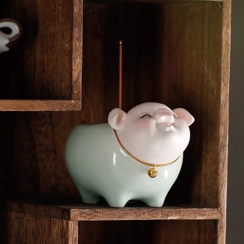 Front eye-level view of ceramic pig incense burner on wooden shelf, incense stick inserted, smiling closed-eye design
