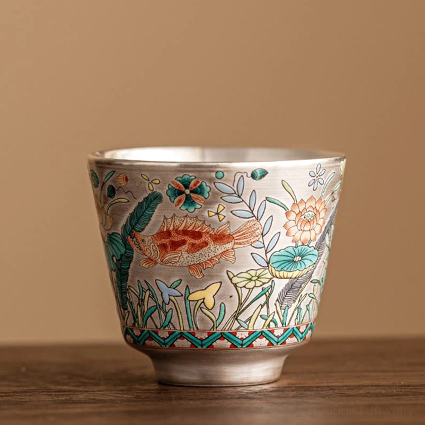 Handcrafted ceramic gongfu tea cup with fish and lotus motif, 45ml capacity, front view on wood table