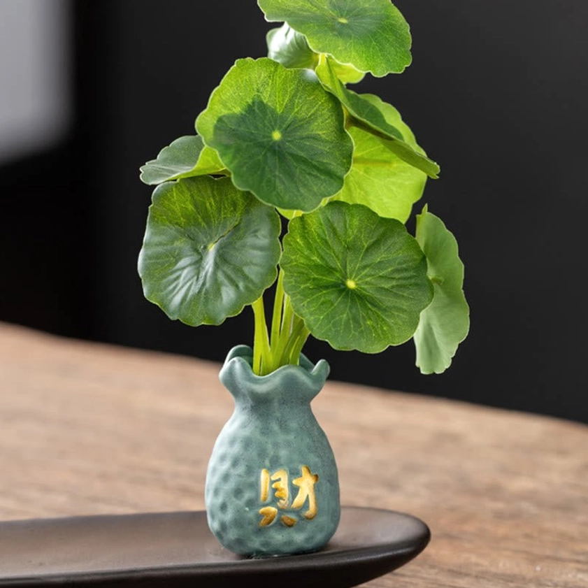 Teal ceramic dimpled vase and matte black elongated incense tray from Buddhist incense burner set overhead view