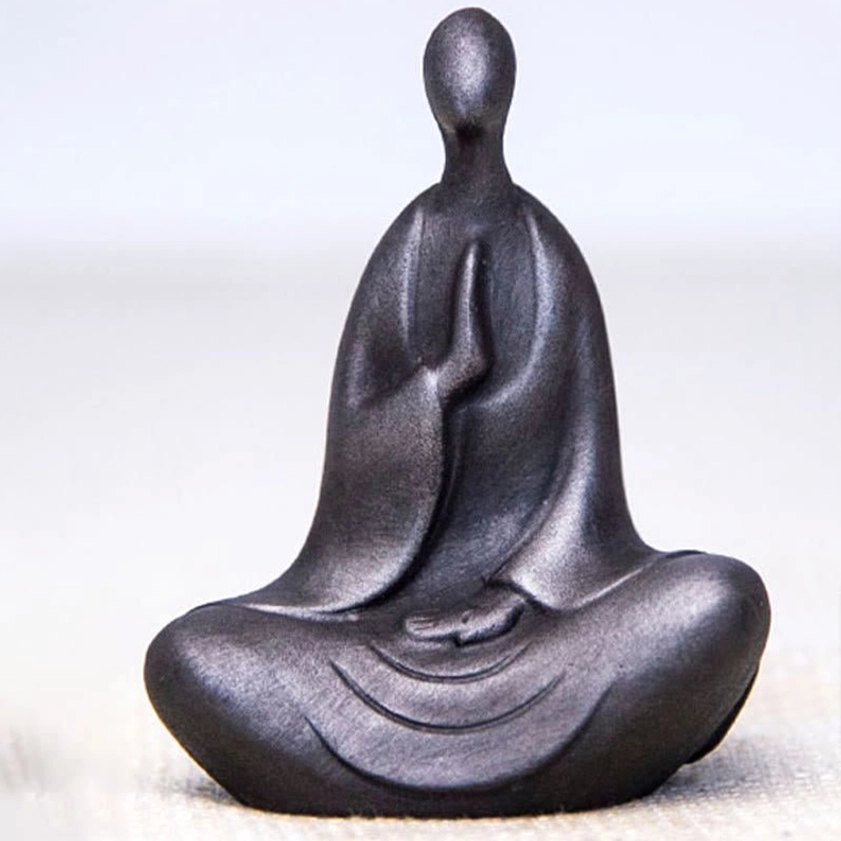 Minimalist Buddha sculpture in solid charcoal gray matte finish with smooth curved robe details close-up