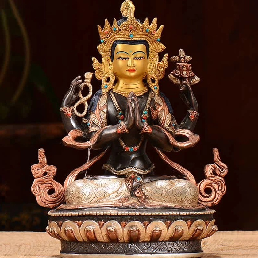 Chenrezig four-armed copper deity statue with ornate crown, golden painted face, and colorful beaded jewelry on silver lotus seat