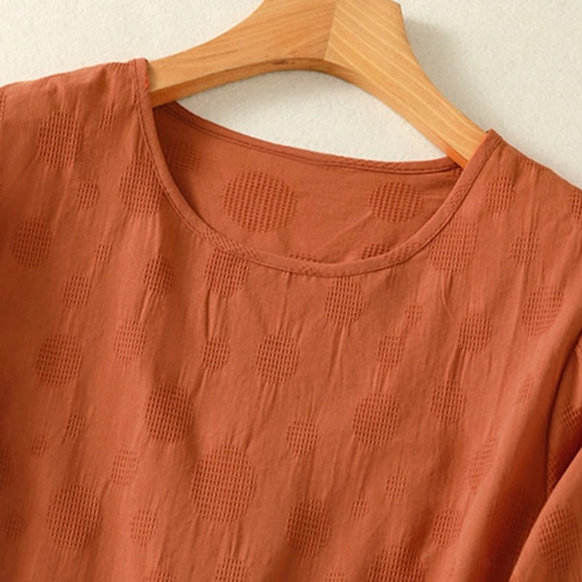 Crew neck neckline of chocolate brown meditation yoga top - close-up showing cotton quality