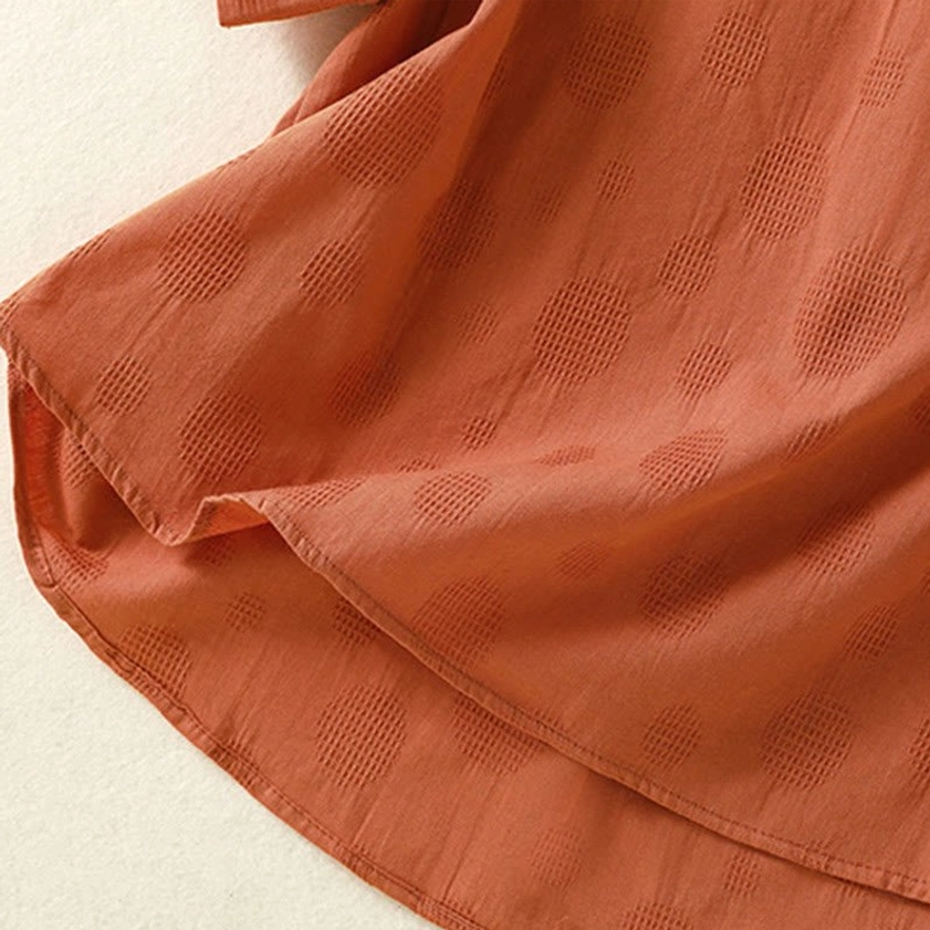Asymmetric hem detail of chocolate brown meditation yoga top - showing curved design closeup