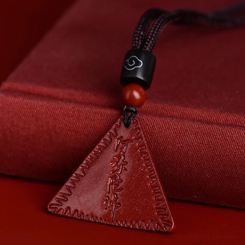 Brown cord cinnabar Amitabha Buddhist pendant necklace variant with braided rope on red display